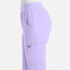 A pair of light lavender women's joggers with side pockets and an elastic waistband. The pants have a logo.