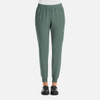 A pair of women's joggers in a green colour with an elastic waistband and side pockets. Features a logo on the leg.