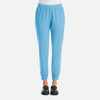 A pair of women's jogger pants in light blue with a fitted ankle and side pockets. The product features a logo.