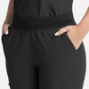 A close-up of women's black flare leg pants featuring a full elastic band and side pockets.