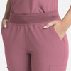 A close-up of women's flare leg pants in a soft pink hue, featuring a full elastic band and side pockets.
