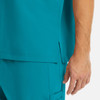 A close-up of a turquoise men's tuckable V-neck top, showcasing the fabric and cut details.