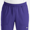 A pair of purple full elastic joggers featuring two front pockets and a logo.