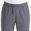 A full elastic jogger in grey featuring multiple pockets and an elastic waistband. The product has a logo.