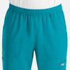 A pair of men's joggers in bright teal, featuring an elastic waistband and pockets, with a logo present.