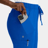 A pair of bright blue cargo pants with an elastic waistband, featuring side pockets and a hand holding a phone.
