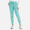 A pair of mint green women's joggers with pockets and an elastic waistband, featuring a logo.