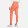 A pair of women's joggers in a bright coral colour, featuring a tapered design and elastic waistband.