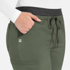 A close-up of women's cargo pants in olive green with a contrast waistband and a side pocket. Features a small logo.
