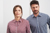 A red and white checked shirt on a woman and a blue and white checked shirt on a man, both featuring button-up designs.