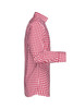 A red and white checked button-up shirt features a classic collar and long sleeves. The shirt has a logo on the fabric.