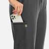 A pair of grey joggers with a pocket holding a smartphone, featuring a small logo.