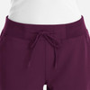 A pair of women's joggers in a deep purple colour with a drawstring waistband and two front pockets.