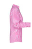 A pink checkered button-up shirt displayed from the side, featuring long sleeves and a collar. It has a logo on it.