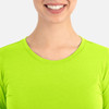 A close-up of a woman's neckline wearing a bright lime green underscrub tee, featuring a simple design and round neck.