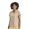 A women's V-neck top featuring a multicoloured heart print, paired with yellow pants. Branding is visible.