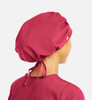 A unisex bouffant scrub cap in a deep pink colour, featuring a gathered design and adjustable ties at the back.