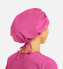 A unisex bouffant cap in vibrant pink, featuring a gathered design and adjustable ties at the back.