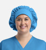 A unisex bouffant scrub cap in vibrant blue, featuring a broad, gathered band and soft fabric.