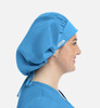 A unisex bouffant scrub cap in bright blue, featuring a logo and a fitted design, shown on a smiling woman.