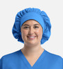 A unisex bouffant scrub cap in bright blue, featuring a gathered design and a fitted upper section.