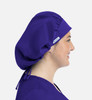 A unisex bouffant cap in purple, featuring a gathering at the back and a side logo.