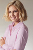 A light pink button-up shirt with a collar, displayed on a smiling woman with short, wavy blonde hair.