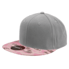 A grey snapback cap with a pink camo patterned brim, featuring a logo on the side.