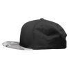 A black snapback cap with a camo-patterned brim and a structured high-profile design. It features a logo.