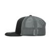 A structured six-panel trucker cap in black with a grey mesh back and adjustable strap.