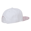 A white snapback cap featuring a patterned pink peak and an adjustable strap at the back.
