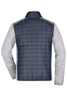 A back view of a men's knitted hybrid jacket featuring a navy quilted body and grey knitted sleeves.
