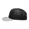 A black and grey 6 panel mid profile structured trucker cap with a mesh back and a logo.