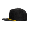 A high-profile black corduroy cap with a yellow accent along the brim and a logo on the front.