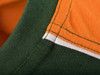 A close-up of a men's workwear t-shirt featuring orange and green fabric with contrasting stitching.
