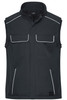 A black softshell vest features front pockets and white piping details, designed for workwear use.