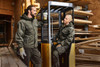 Workwear Softshell Padded Jacket in dark green, featuring a logo, displayed by two people in a construction setting.
