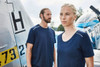A navy blue men's workwear T-shirt displayed on a model, featuring a simple design with a logo.