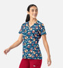 A V-neck print top featuring a colourful pattern of festive motifs on a navy background. The shirt has a logo on it.