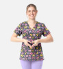 A woman wears a multicoloured V-neck top with a floral print, featuring a variety of shapes and colours.