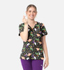 A women's V-neck print top featuring a vibrant pattern of animals and whimsical designs against a black background.
