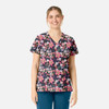 A floral women's V-neck top featuring pink, white, and purple flowers on a dark background, with a branded logo.