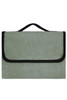 A green picnic blanket with a black edge and a handle for carrying. It has a soft, plush texture.