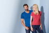 A blue men's V-T shirt and a pink women's V-T shirt are displayed on a light background. Both models are smiling.