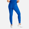 A pair of mid-rise jogger pants in bright blue, featuring an elastic waistband and a branding logo, with fitted cuffs.