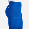 A side view of bright blue mid-rise jogger pants featuring a side pocket and branding.