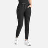 Tapered leg pants in black with an elasticated waistband and side pockets, worn with white sneakers.