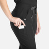 A pair of black tapered leg pants with pockets, featuring a drawstring waist and a logo branding detail.