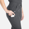 Grey tapered leg pants with pockets, featuring a hand reaching for a phone in the side pocket.