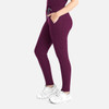 A tapered leg pant in deep burgundy, featuring side pockets and a drawstring waist. The model pairs them with white shoes.
